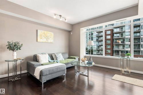 Expansive window wall, recessed lighting, wood-finish flooring, and neutral wall tones - #416 2510 109 St Nw, Edmonton, AB 