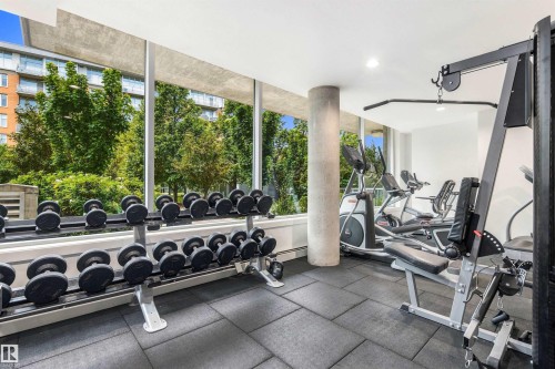 Fitness center featuring extensive full-height windows, rubber tile flooring, and integrated lighting - #416 2510 109 St Nw, Edmonton, AB 