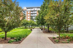 Expansive lawn area with mature trees and landscaped beds - 