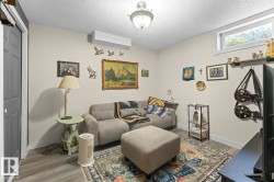 Interior space featuring light gray walls and wood-finish flooring - 