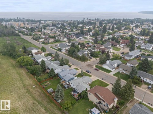Aerial perspective of a residential neighborhood featuring established homes and mature landscaping - 1303 12 Street, Cold Lake, AB 