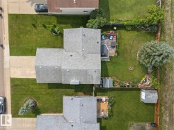 Aerial view showcasing a property with a grey shingle roof - 