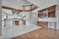 Gourmet kitchen with white cabinetry and stainless steel appliances - 