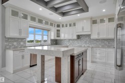 White shaker cabinetry with glass-front accents - 