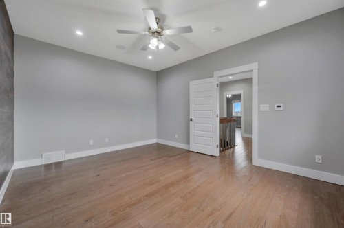 Hardwood-style flooring, recessed lighting, and a ceiling fan with integrated lighting - 9054 24 Avenue Sw, Edmonton, AB 
