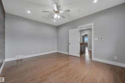 Hardwood-style flooring, recessed lighting, and a ceiling fan with integrated lighting - 