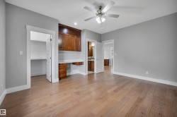 Wood-finish flooring, built-in cabinetry, recessed lighting, ceiling fan, and painted walls - 