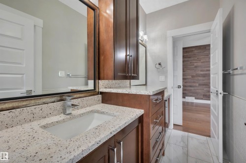 Dual dark wood-finish vanities with granite-style countertops - 9054 24 Avenue Sw, Edmonton, AB 
