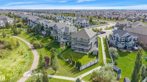 Contemporary residential architecture with multi-level balconies, expansive green space, and a paved walking path - 9054 24 Avenue Sw, Edmonton, AB 