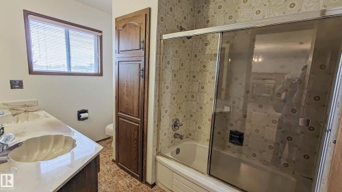 Dual vanity with integrated sinks and a light-colored countertop - 3031 79 Street Nw, Edmonton, AB 
