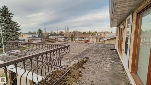 Upper-level balcony with wrought iron railing and direct exterior access - 3031 79 Street Nw, Edmonton, AB 