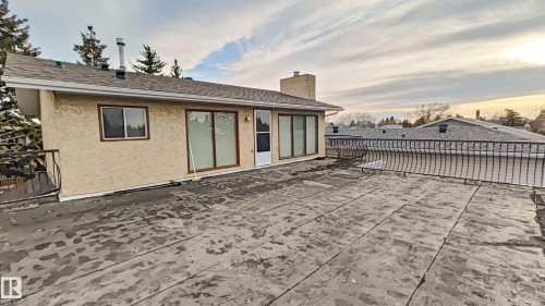 Expansive rooftop deck with decorative metal railing and direct entry to the interior - 3031 79 Street Nw, Edmonton, AB 