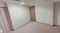Neutral wall paint, plush carpet flooring, wood-finish bi-fold closet doors, and recessed ceiling lighting - 
