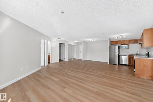 Wood-finish flooring, light gray wall paint, and white trim - #1303 330 Clareview Station Dr Nw, Edmonton, AB 