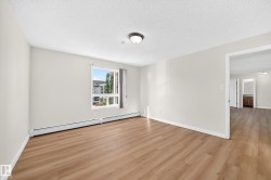 Wood-finish flooring, neutral wall tones, window with vertical blinds, and ceiling-mounted lighting fixture - 