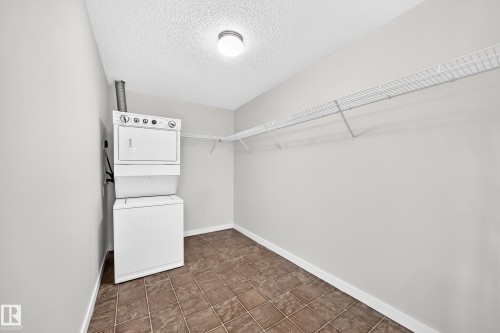Laundry area with tile flooring and wire shelving - #1303 330 Clareview Station Dr Nw, Edmonton, AB 