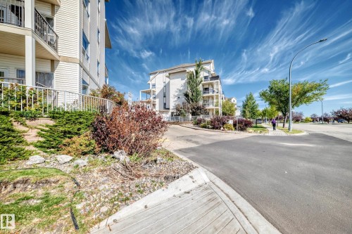 Multi-level building with white siding and individual balconies - #1303 330 Clareview Station Dr Nw, Edmonton, AB 