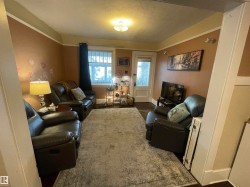 Warm-toned walls with decorative accents, recessed window with white trim, interior door with frosted glass, and ceiling-mounted light fixture - 