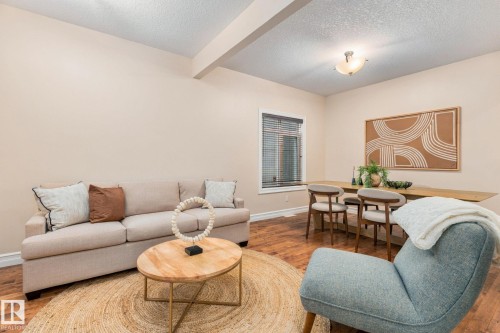 Wood-finish flooring throughout, neutral wall tones, and recessed ceiling beams - 10143 123 Street Nw, Edmonton, AB 