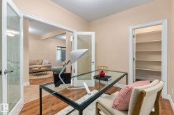 Wood-finish flooring throughout, complemented by a built-in shelving unit - 
