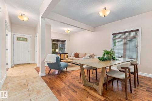 Hardwood flooring, tiled entryway, white paneled door with decorative glass, and recessed lighting - 10143 123 Street Nw, Edmonton, AB 