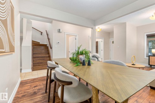 Wood-finish flooring throughout, featuring a natural wood staircase with a matching handrail - 10143 123 Street Nw, Edmonton, AB 