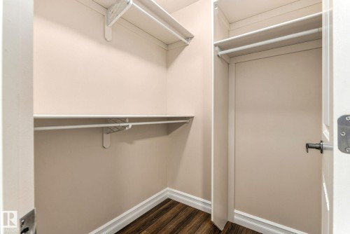 Walk-in closet with multi-level shelving, hanging rods, and wood-finish flooring - 10143 123 Street Nw, Edmonton, AB 