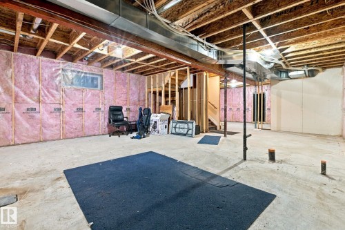 Unfinished basement with exposed ceiling joists, concrete flooring, and insulated walls - 10143 123 Street Nw, Edmonton, AB 