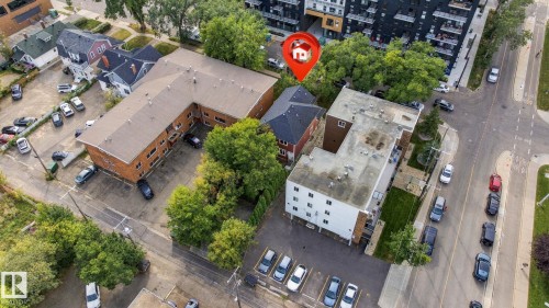 Multi-building property featuring a brick exterior structure and an adjacent white-sided building with a flat roof - 10143 123 Street Nw, Edmonton, AB 