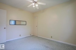 Carpeted flooring, ceiling fan with integrated lighting, and neutral wall paint - 