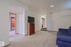 Carpeted flooring, recessed ceiling lighting, light-toned wall finishes, and wood-trim doorways - 