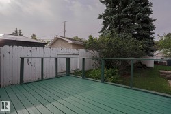 Wood deck with green finish and perimeter railing - 