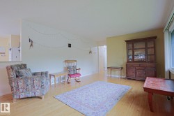 Hardwood-finish flooring, half-wall partition, and light-colored wall paint - 