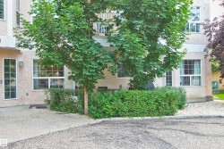 Light stucco exterior with multiple large windows and a glass-paneled door - 