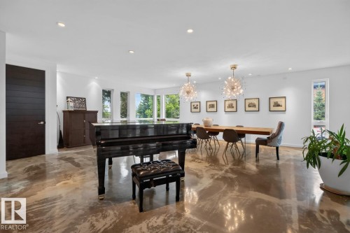 Polished concrete flooring, recessed lighting, and modern light fixtures define this expansive open space - 14A Birch Drive, St. Albert, AB 