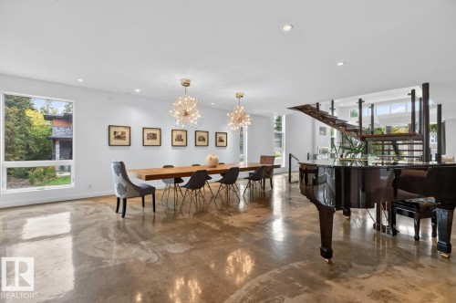 Polished concrete flooring, recessed lighting, and a floating staircase with glass panels - 14A Birch Drive, St. Albert, AB 