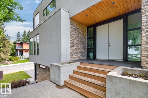 Modern exterior featuring stucco and stacked stone accents - 14A Birch Drive, St. Albert, AB 