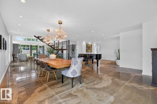 Polished concrete flooring, recessed lighting, and a modern open staircase - 14A Birch Drive, St. Albert, AB 