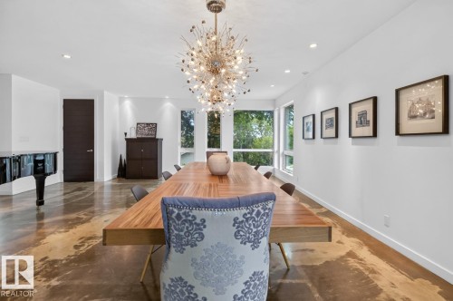 Polished concrete flooring, recessed lighting, and a unique central chandelier - 14A Birch Drive, St. Albert, AB 