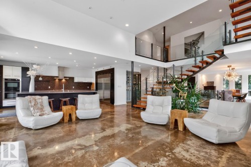 Open-concept living space featuring high ceilings and polished concrete flooring - 14A Birch Drive, St. Albert, AB 