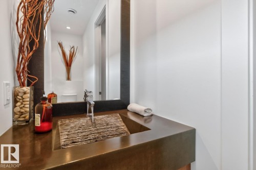 Floating vanity with a textured basin sink and a single-handle faucet - 14A Birch Drive, St. Albert, AB 