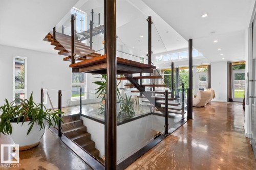 Open-tread staircase with glass railings and wood steps - 14A Birch Drive, St. Albert, AB 