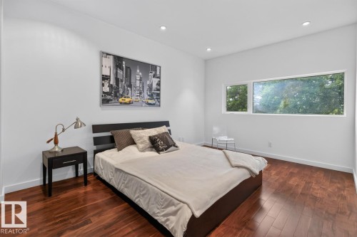 White walls, recessed lighting, wood-finish flooring, and large horizontal windows - 14A Birch Drive, St. Albert, AB 