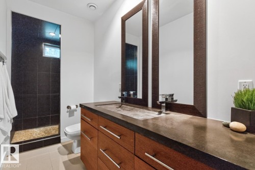 Wood-finish vanity with chrome hardware, dual sinks, and two framed mirrors - 14A Birch Drive, St. Albert, AB 