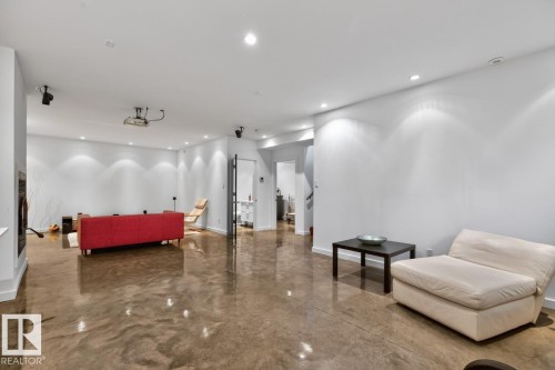 Expansive open-concept living space with polished concrete flooring and recessed lighting - 14A Birch Drive, St. Albert, AB 
