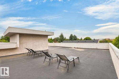 Rooftop patio with stucco-finished parapet walls and an expansive flat surface - 14A Birch Drive, St. Albert, AB 