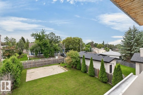 Expansive green lawn with a concrete pad and mature trees - 14A Birch Drive, St. Albert, AB 