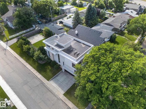Modern exterior architecture featuring a flat roof and a concrete driveway - 14A Birch Drive, St. Albert, AB 