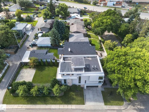 Contemporary architecture with a flat roofline, integrated garage, and a concrete driveway - 14A Birch Drive, St. Albert, AB 