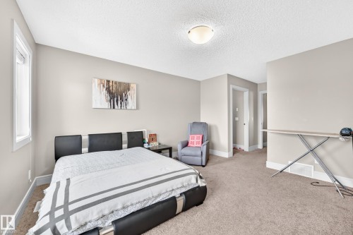 Carpeted room featuring light-colored walls and a window - 12035 168 Avenue Nw, Edmonton, AB 